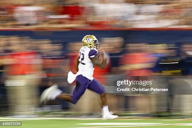 Running back Lavon Coleman of the Washington Huskies carries the football en route to scoring a 55 yard rushing touchdown against the Arizona...