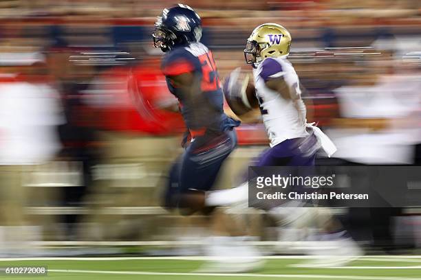 Running back Lavon Coleman of the Washington Huskies rushes the football against the Arizona Wildcats during the college football game at Arizona...