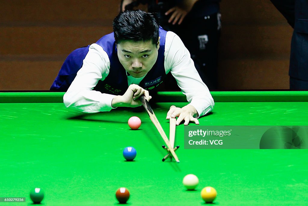 Ding Junhui of China plays a shot in the final match against Mark