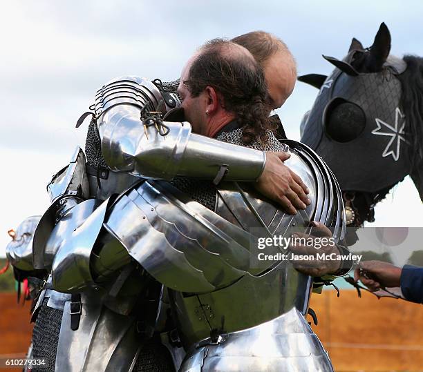 Cliff Marisma of Australia is embraced by Arne Koets of The Netherlands after winning the Jousting tournament during the Medieval Faire at St Ives...