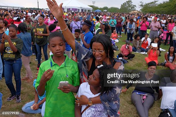 Janice Woodward of Chicago, and her daughter, Landyn Haywood and son Grayson listen to President Barack Obama during he dedication of the grand...