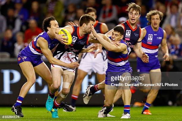 Alex Neal-Bullen of Casey is tackled during the VFL Grand Final match between the Casey Scorpions and the Footscray Bulldogs at Etihad Stadium on...