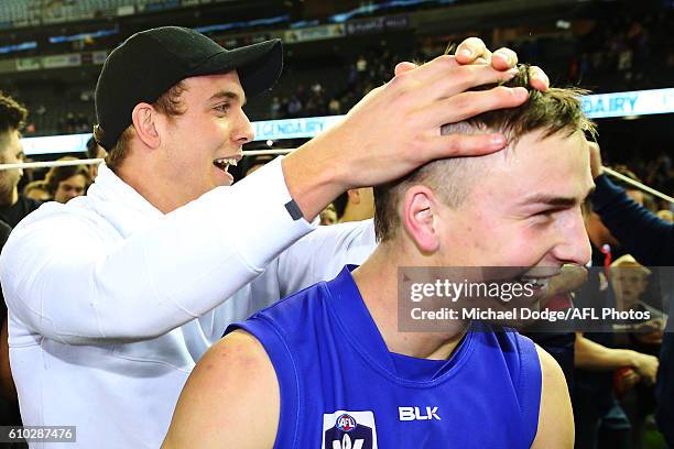 The injure Mitch Wallis of the Bulldogs celebrates the win with Mitch Honeychurch of Footscray during the VFL Grand Final match between the Casey...