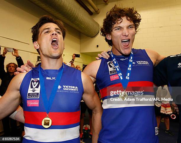 Jed Adcock and Will Minson of the Bulldogs sing the team song during the VFL Grand Final match between Footscray Bulldogs and Casey Scorpions at...