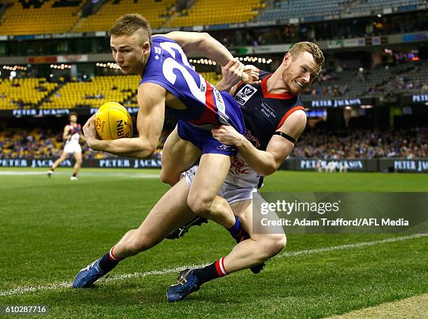 Mitch Honeychurch of the Bulldogs is tackled by Mitch White of the Scorpions during the VFL Grand Final match between Footscray Bulldogs and Casey...