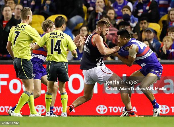 Lynden Dunn of the Scorpions remonstrates with Lin Jong of the Bulldogs during the VFL Grand Final match between Footscray Bulldogs and Casey...