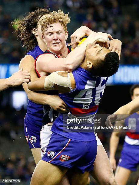 Clayton Oliver of the Scorpions is tackled by Lin Jong of the Bulldogs during the VFL Grand Final match between Footscray Bulldogs and Casey...