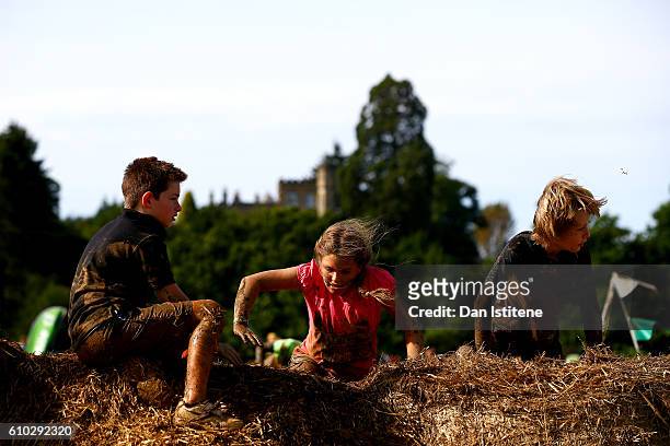 Young participants tackle the Mini Mudder during the 2016 Tough Mudder - London South at Holmbush Farm on September 24, 2016 in Horsham, England.