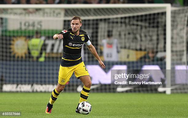 Marcel Schmelzer of Dortmund runs with the ball during the Bundesliga match between VfL Wolfsburg and Borussia Dortmund at Volkswagen Arena on...