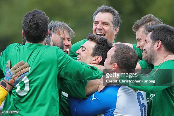 Britain's Shadow Home Secretary, Andy Burnham , and Labour MPs celebrate winning the match after comedian John Bishop scored the winning penalty...