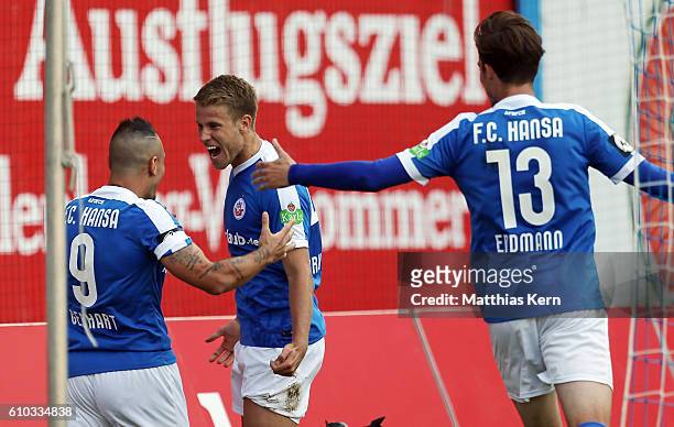 Tommy Grupe of Rostock jubilates with team mates after scoring the second goal during the third league match between FC Hansa Rostock and FSV Zwickau...