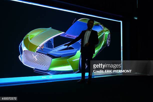 French carmaker DS design director Thierry Metroz gives presentation with a 3D rendering of the DS electric E-Tense Concept car, on September 9 at...