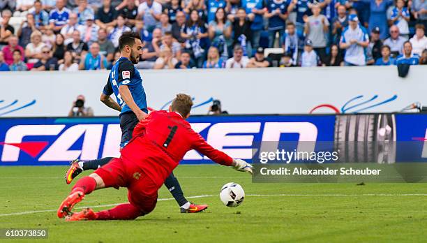 Lukas Rupp of Hoffenheim scores the second goal for his team against Ralf Faehrmann of Schalke during the Bundesliga match between TSG 1899...