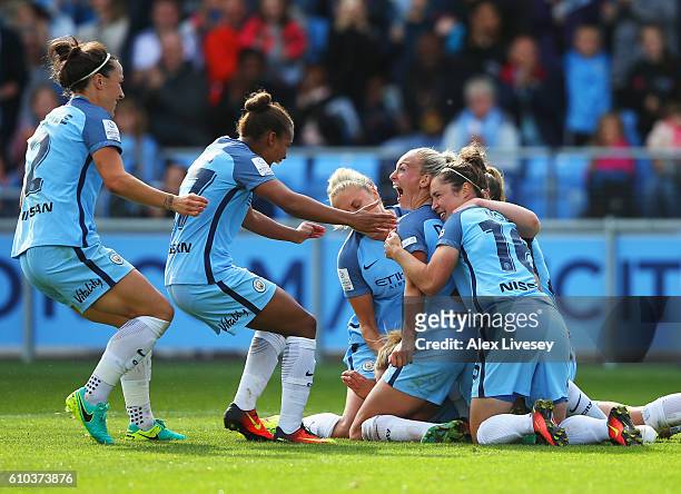 Toni Duggan of Manchester City Women celebrates with team mates as she scores their second goal from a penalty during the WSL 1 match between...