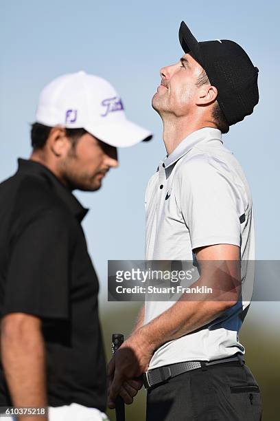 Ross Fisher of England reacts to a missed oppertunity as Alexander Levy of France looks on during the final round of the Porsche European Open at...