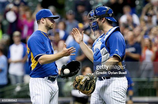 Tyler Thornburg and Andrew Susac of the Milwaukee Brewers celebrate after beating the Cincinnati Reds 5-4 at Miller Park on September 23, 2016 in...