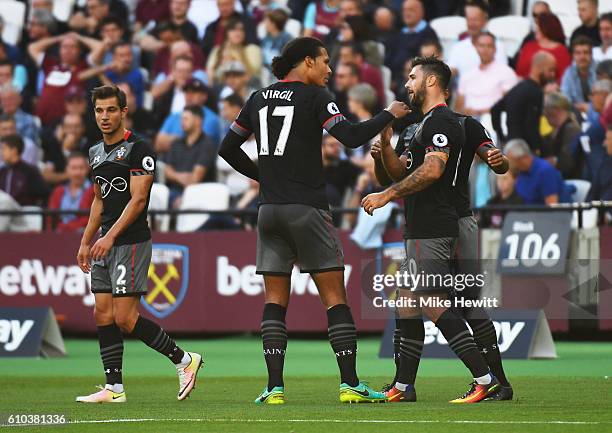 Charlie Austin of Southampton celebrates with Virgil van Dijk as he scores their first goal during the Premier League match between West Ham United...