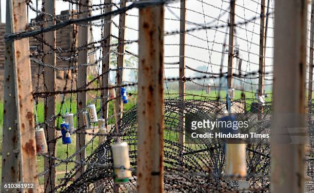 Empty canisters of soft drinks tied up with barbed fence at a forward location on Indo-Pak border, on September 25, 2016 in Jammu, India.