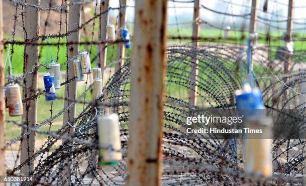 Empty canisters of soft drinks tied up with barbed fence at a forward location on Indo-Pak border, on September 25, 2016 in Jammu, India.