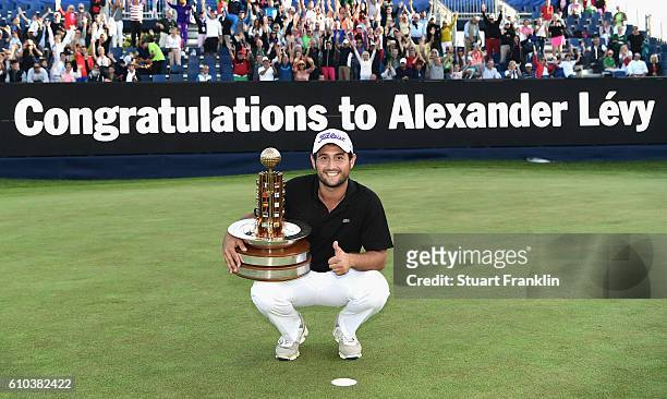 Alexander Levy of France poses with the trophy after winning in the final round of the Porsche European Open at Golf Resort Bad Griesbach on...