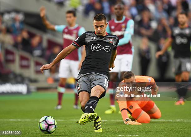 Dusan Tadic of Southampton beats Adrian of West Ham United as he scores their second goal during the Premier League match between West Ham United and...