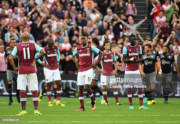 West Ham players look dejected as James Ward-Prowse of Southampton scores their third goal during the Premier League match between West Ham United...