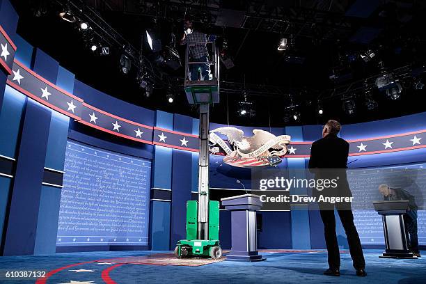 Workers make adjustments to the set for the first U.S. Presidential debate at Hofstra University on September 25, 2016 in Hempstead, New York....