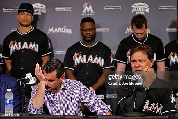 Miami Marlins team president David Samson, front left, manager Don Mattingly and players behind from left, Giancarlo Stanton, Fernando Rodney and...