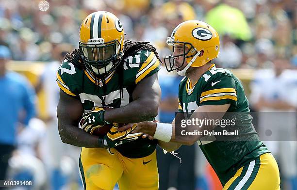 Aaron Rodgers of the Green Bay Packers hands the ball off to Eddie Lacy in the second quarter against the Detroit Lions at Lambeau Field on September...