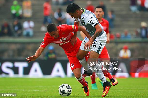 Carlos Esquivel of Toluca struggles for the ball with Leonel Lopez of Leon during the 11th round match between Toluca and Leon as part of the Torneo...