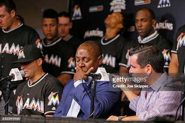 Miami Marlins team president David Samson, right, comforts Marlins president of baseball operations, Michael Hill during a press conference after...