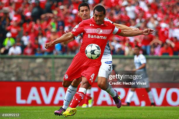 Paulo Da Silva of Toluca struggles for the ball with Guillermo Burdisso of Leon during the 11th round match between Toluca and Leon as part of the...