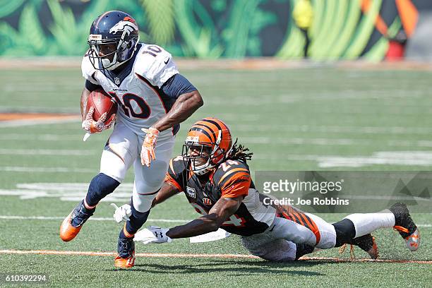 Emmanuel Sanders of the Denver Broncos breaks a tackle by Adam Jones of the Cincinnati Bengals during the first quarter at Paul Brown Stadium on...