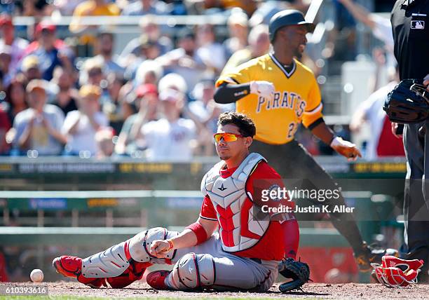 Andrew McCutchen of the Pittsburgh Pirates scores past Jose Lobaton of the Washington Nationals in the first inning on a foul out to the catcher...