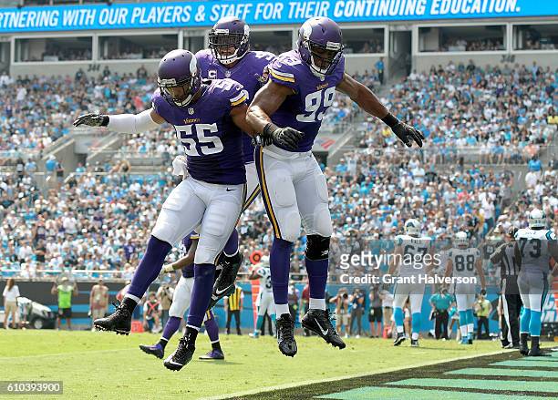 Danielle Hunter of the Minnesota Vikings celebrates with teammates after sacking Cam Newton of the Carolina Panthers for a safety during the game at...