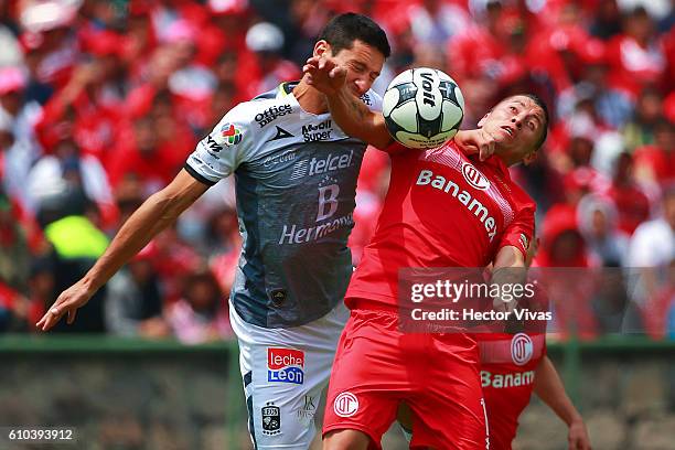 Carlos Esquivel of Toluca struggles for the ball with Guillermo Burdisso of Leon during the 11th round match between Toluca and Leon as part of the...