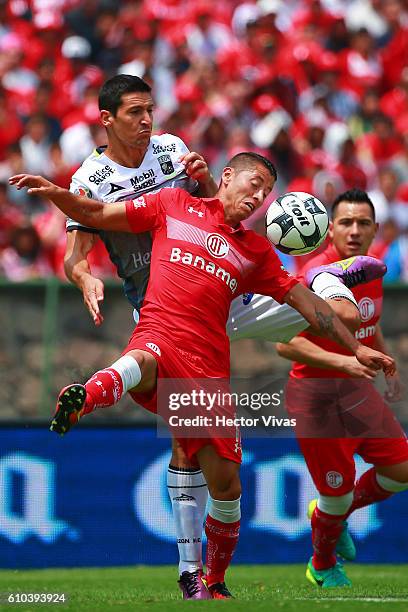 Carlos Esquivel of Toluca struggles for the ball with Guillermo Burdisso of Leon during the 11th round match between Toluca and Leon as part of the...