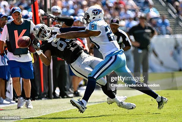 Perrish Cox of the Tennessee Titans pushes Amari Cooper of the Oakland Raiders out of bounds causing an incompletion during the first half at Nissan...