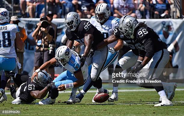 Bruce Irvin of the Oakland Raiders causes quarterback Marcus Mariota of the Tennessee Titans to fumble during the first half at Nissan Stadium on...