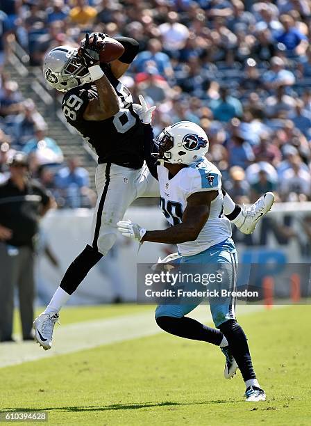 Amari Cooper of the Oakland Raiders jumps for a reception over Perrish Cox of the Tennessee Titans during the first half at Nissan Stadium on...