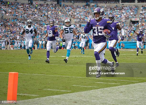 Marcus Sherels of the Minnesota Vikings returns a punt for a touchdown against the Carolina Panthers during the game at Bank of America Stadium on...