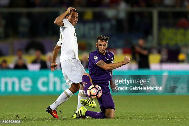 Gonzalo Rodriguez of ACF Fiorentina fights for the ball with Carlos Bacca of AC Milan during the Serie A match between ACF Fiorentina and AC Milan at...
