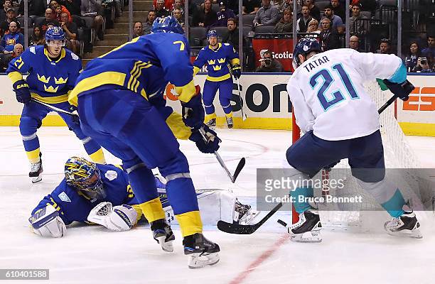 Tomas Tatar of Team Europe scores the game winning goal in overtime past a defending Henrik Lundqvist and Victor Hedman of Team Sweden at the...