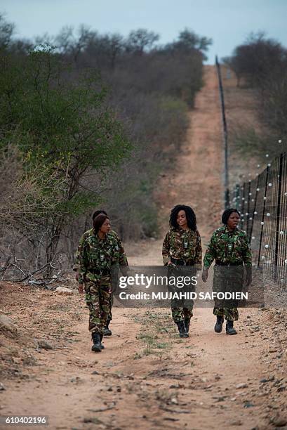 Female members of the anti-poaching team "Black Mamba" perform a routine patrol through a wildlife reserve on September 25, 2016 in Hoedspruit, in...