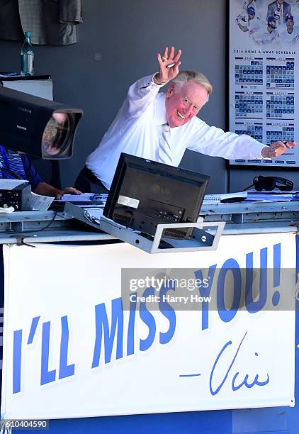 Los Angeles Dodgers announcer Vin Scully waves to the crowd before his final home game after 67 years at the post before the game against the...