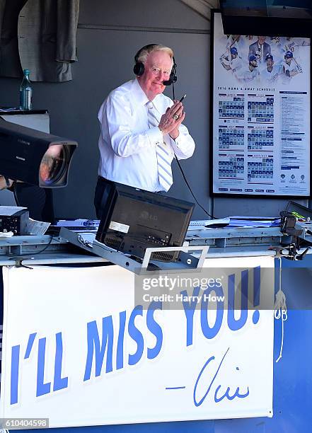Los Angeles Dodgers announcer Vin Scully motions to the crowd before his final home game after 67 years at the post before the game against the...