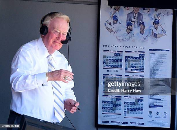 Los Angeles Dodgers announcer Vin Scully smiles to the crowd before his final home game after 67 years at the post before the game against the...
