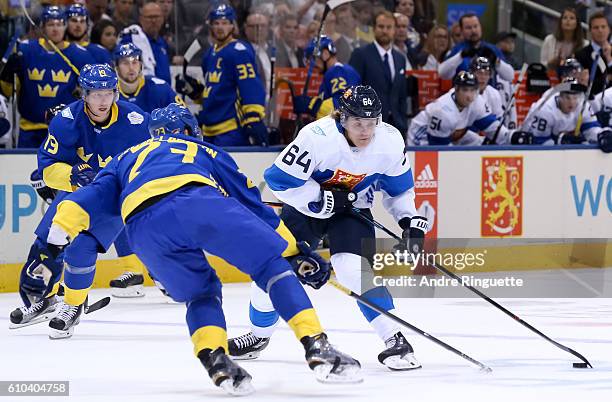 Mikael Granlund of Team Finland stickhandles the puck away from Oliver Ekman-Larsson of Team Sweden during the World Cup of Hockey 2016 at Air Canada...