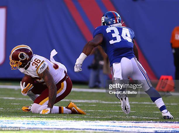 Su'a Cravens of the Washington Redskins makes a game saving interception in the closing minutes against Shane Vereen of the New York Giants in the...