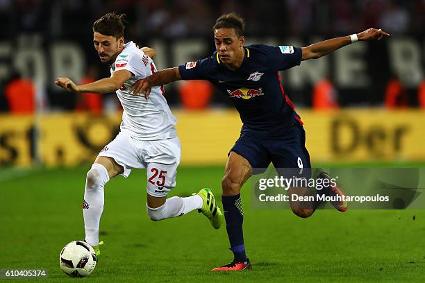 Filip Mladenovic of Koeln battles for the ball with Yussuf Poulsen of RB Leipzig during the Bundesliga match between 1. FC Koeln and RB Leipzig at...